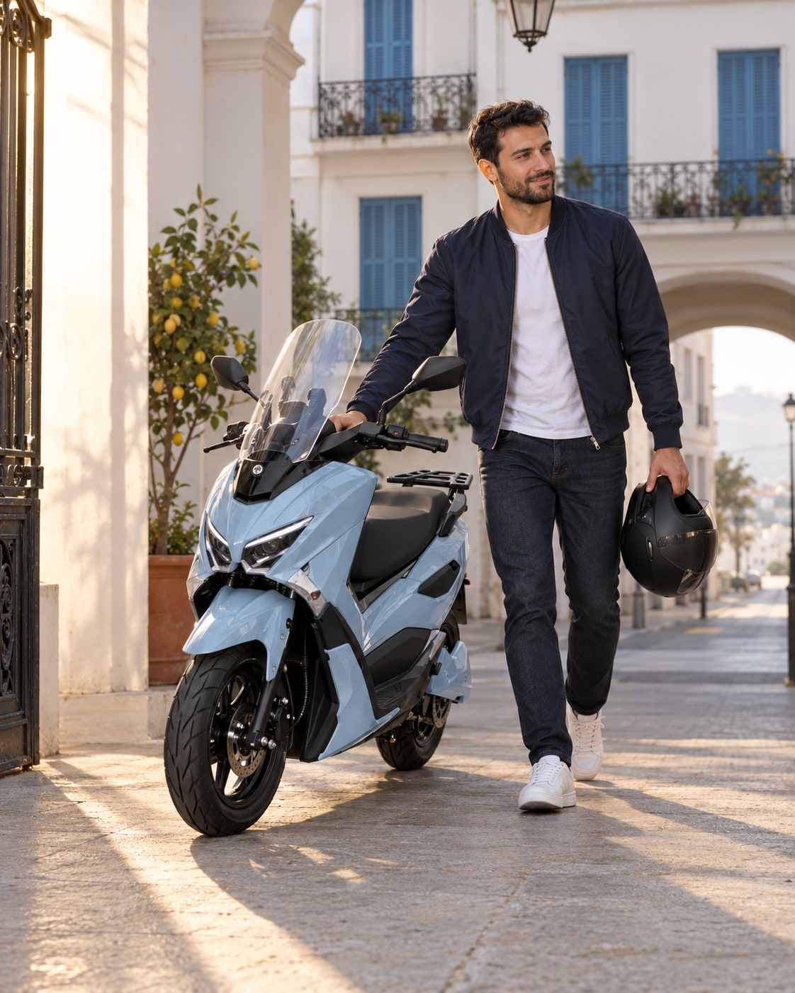 A rider wheels a Potensia out of a residential building’s courtyard in soft morning light