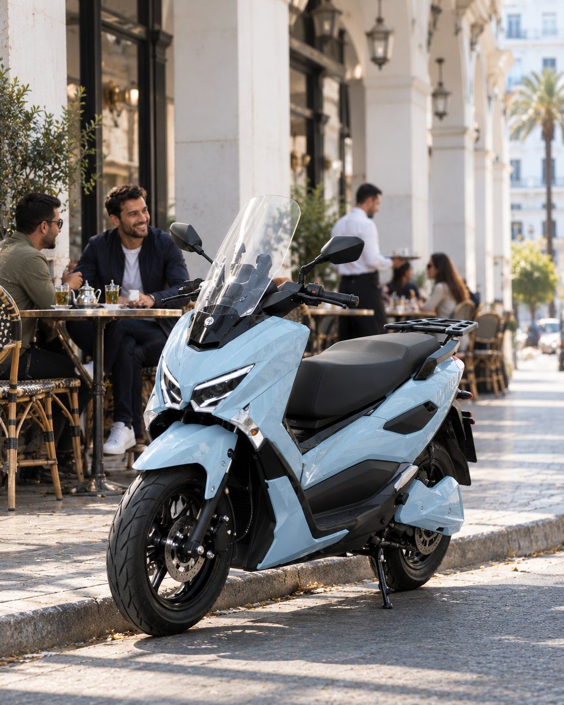 A Potensia parked on the pavement outside a café terrace at lunchtime